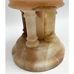 Classical style pink alabaster font, the turned cylindrical well upon four columns and central support, the whole upon a spreading circular foot, overall H21cm well D16.5cm
