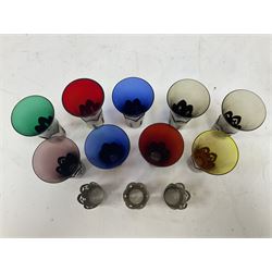 Fluted glasses of various colours, encased in silver plated mounts with pierced decoration  