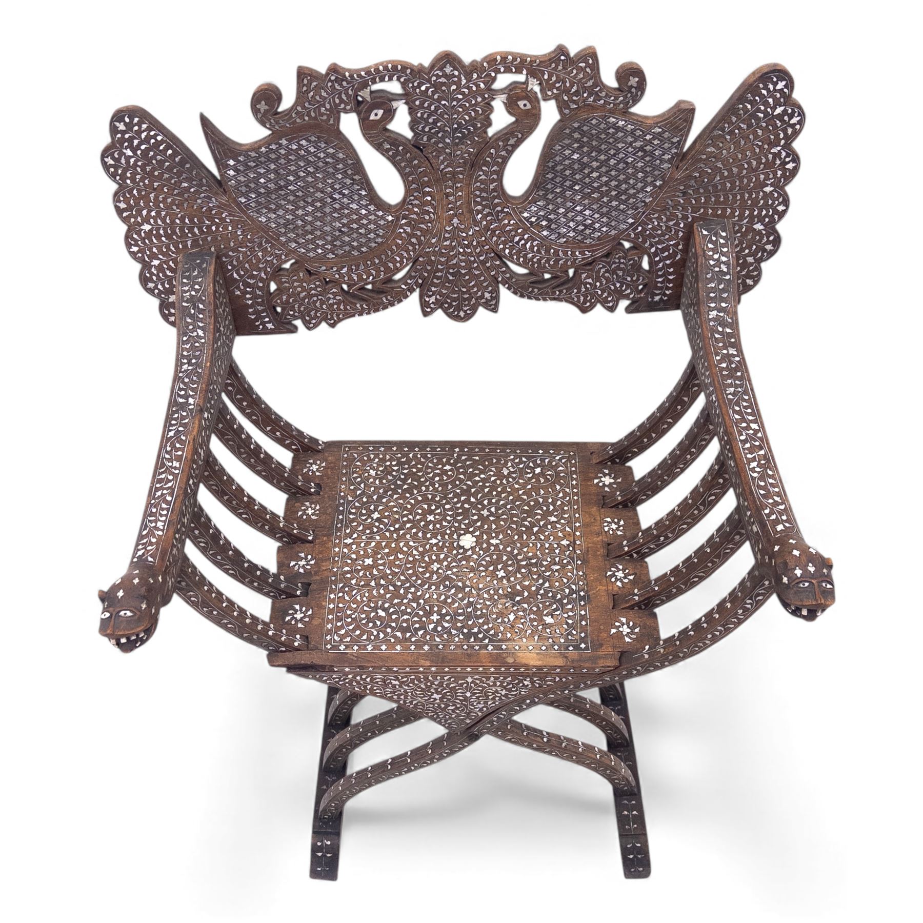 Anglo-Indian bone inlaid hardwood Savonarola chair, the pierced back finely carved with opposing peacocks amongst scrolling foliage, the seat, arms, and X-frame supports. This item has been registered for sale under section 10 of the APHA Ivory Act Reference QWLLGKZM