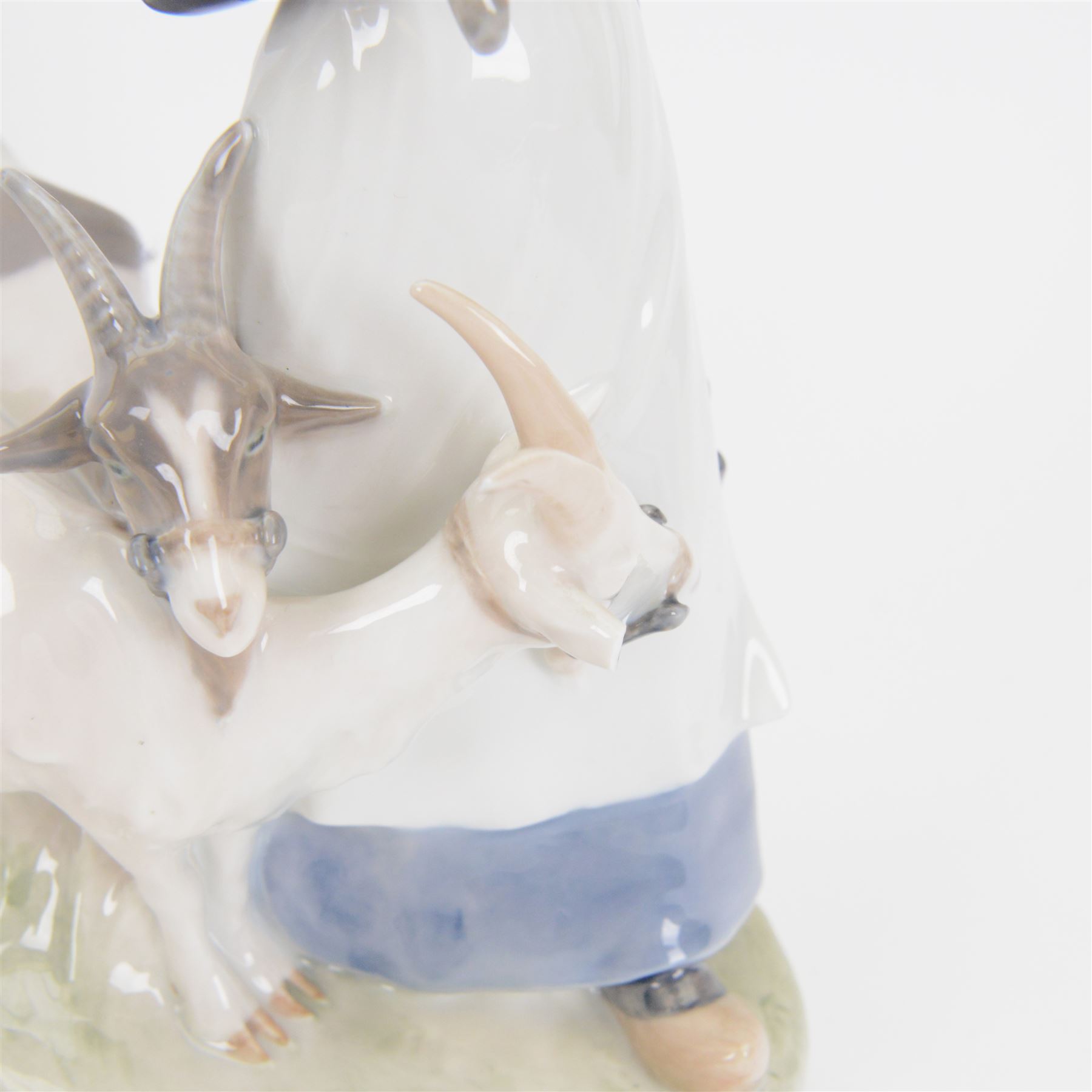 Five Royal Copenhagen porcelain figures of farm animals, comprising Boy with Pig no 848, Boy with Calf no.772, Boy with Sheep no 627, Boy with Calf's no.1858, Girl with Goats no 694