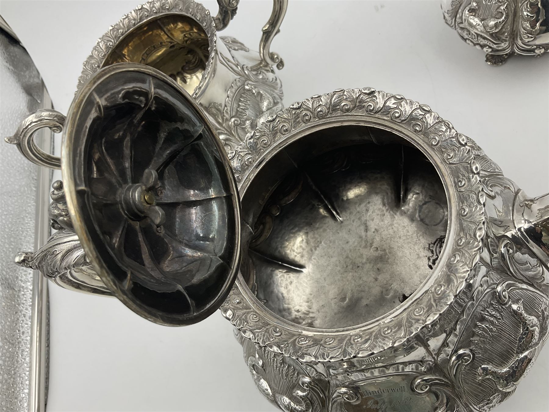 Victorian silver three piece tea service, comprising teapot, twin handled open sucrier, and milk jug, each of bellied form with acanthus capped scroll handles, the sides embossed with alternating scroll edged vacant panels and panels containing a pair of birds, upon four palmette feet, the teapot with ivory insulators to handle, and bird finial to the hinged domed cover, hallmarked William Hunter & Son, London 1861, teapot H19cm, including handles sucrier H13.5cm, including handle milk jug H12cm

This item has been registered for sale under Section 10 of the APHA Ivory Act