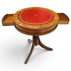 Regency style mahogany drum table, circular red leather inset top with gilt and blind tooling, bird's-eye maple crossbanded border, fitted with two opposing pull-out slides, on turned pedestal and three outswept support