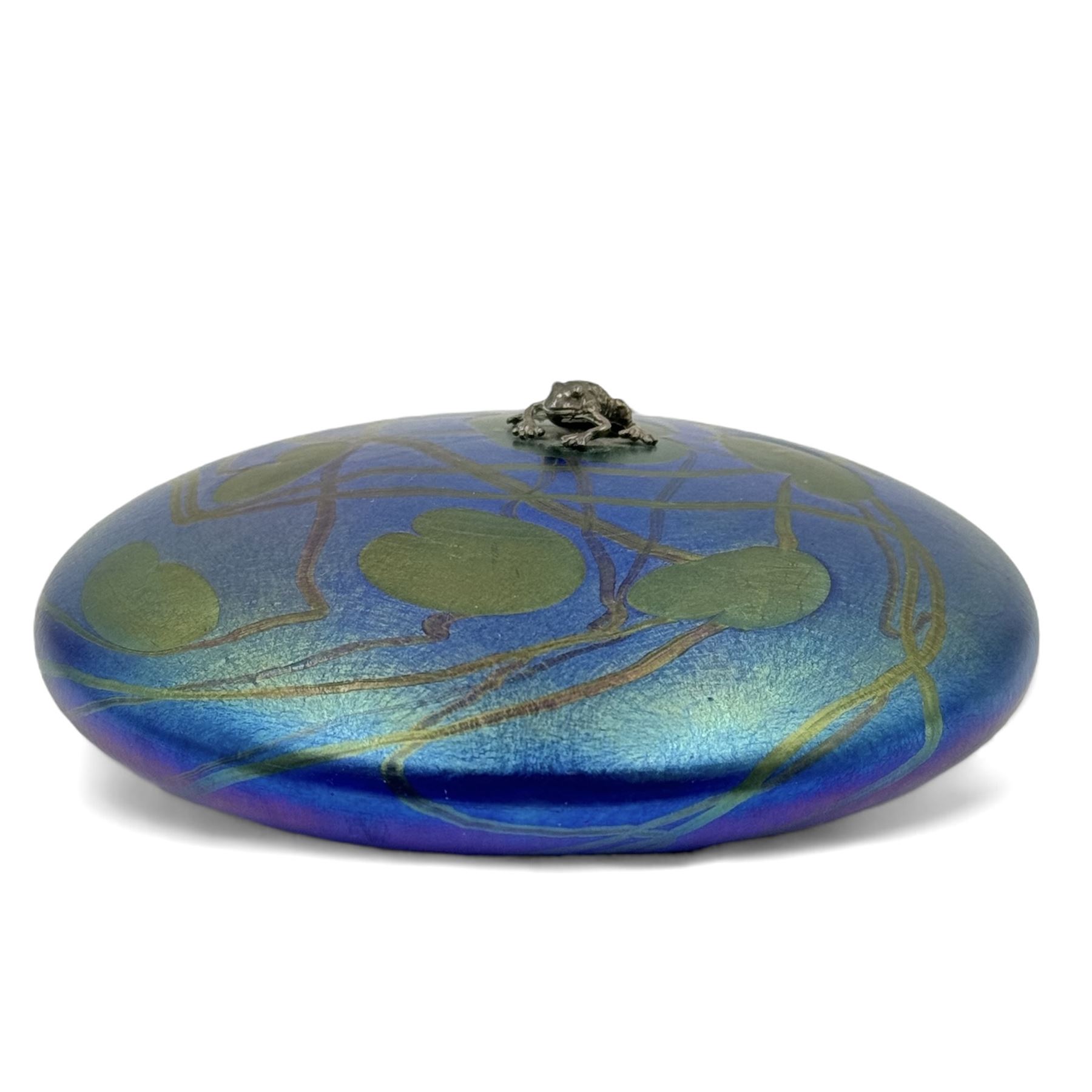 John Ditchfield for Glasform disc paperweight in iridescent blue with green lily trail and silver hallmarked frog to top, D13cm