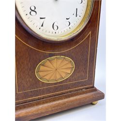 Edwardian inlaid mahogany mantel clock, stepped cavetto and arched top pediment, circular white enamel Roman dial signed 'A & J. Thompson, Scarborough', the front inlaid with fan motif, raised on globular brass feet, single train driven movement by 'R & Co. Paris'