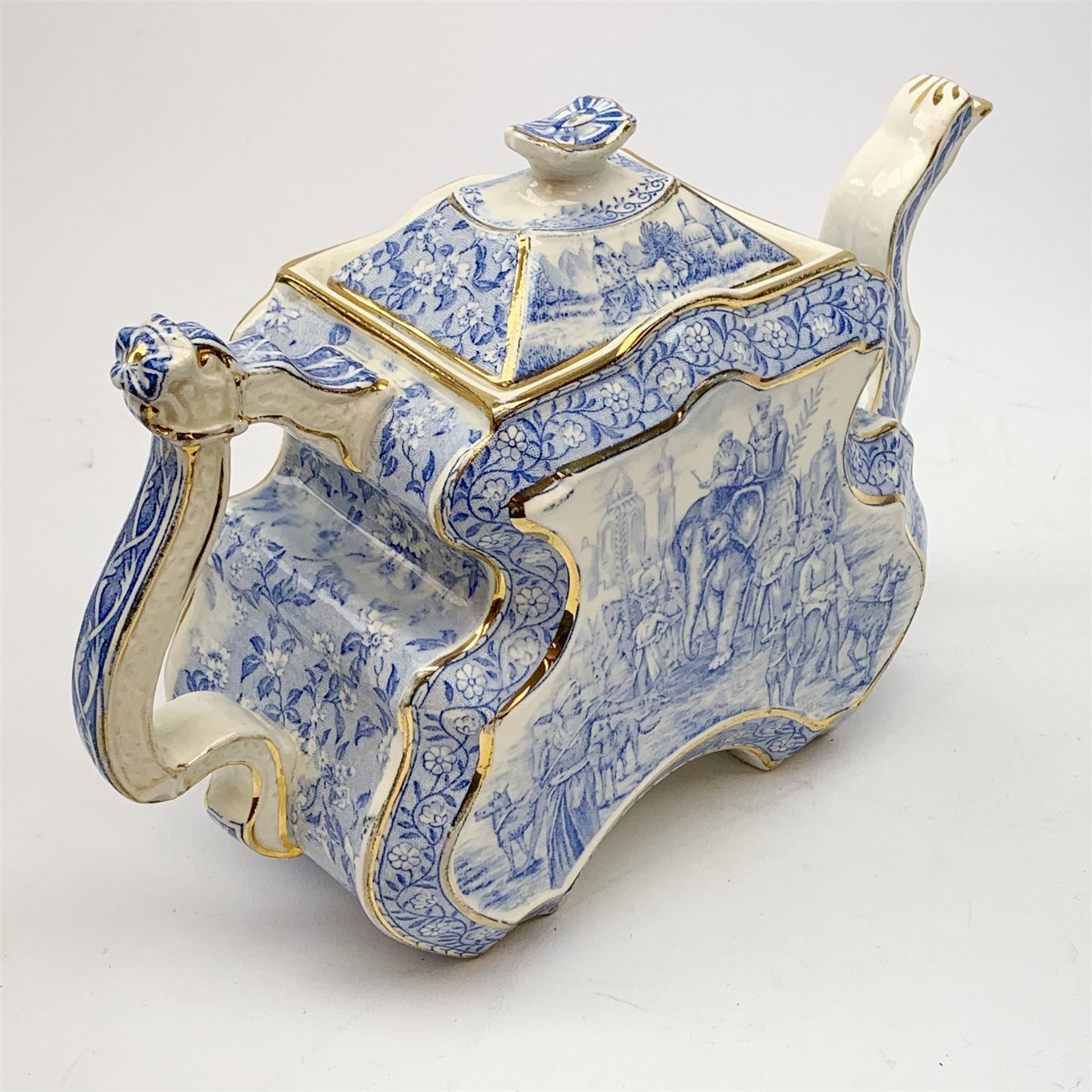 A Victorian Burgess and Leigh Aesthetic style blue and white teapot, decorated with an Indian hunting scene and heightened with gilt to edges, H17cm. 
