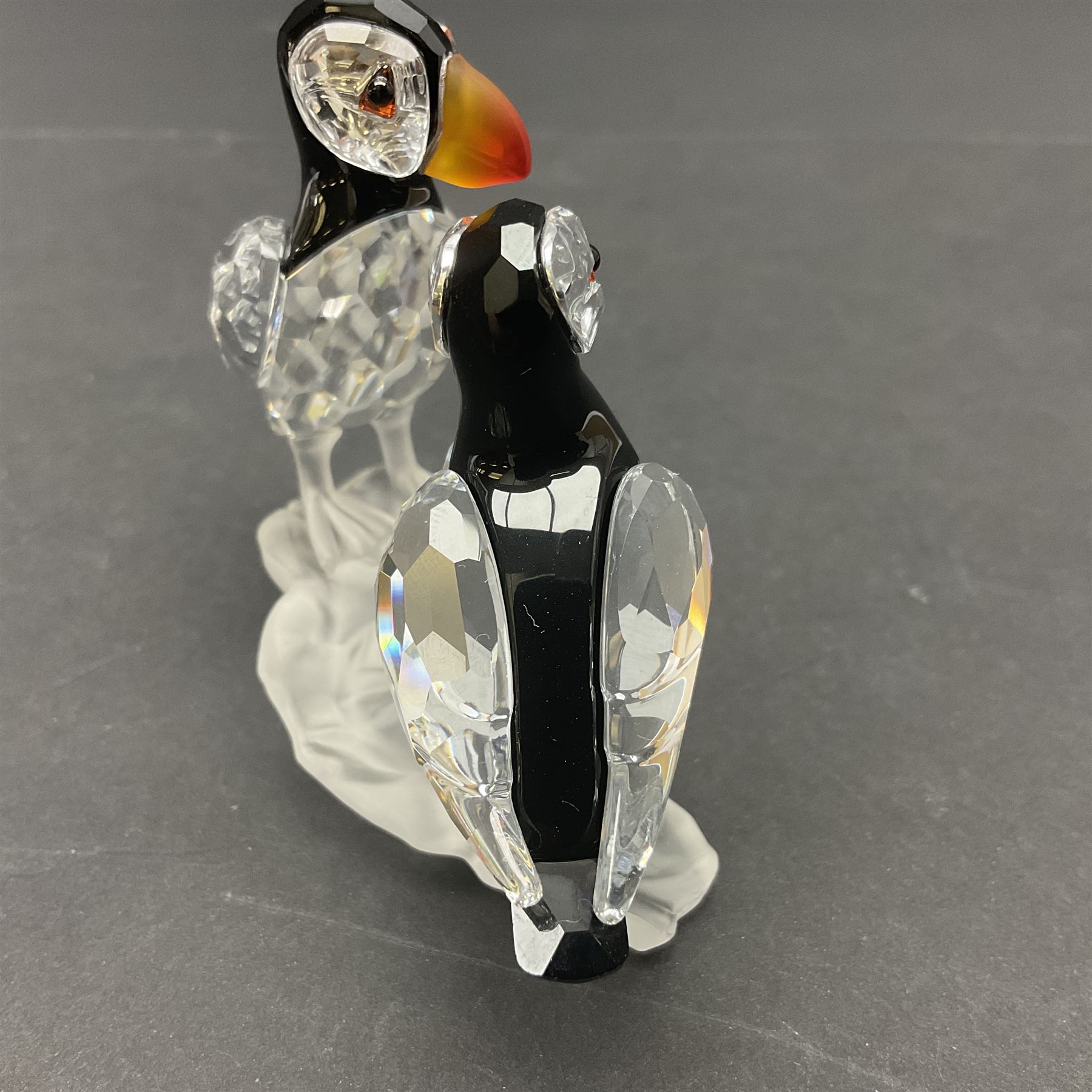 Three Swarovski Crystal bird figures, comprising Toucan, pair of puffins and pair of parrots on a branch, tallest H10cm