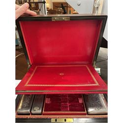  Victorian brass inlaid rosewood dressing table box, retailed by F.L. Hausburg, Liverpool, the lid centred by a brass cartouche, opening to reveal letter store to lid underside, above a fitted interior, with ten mounted cut glass jars, bottles and manicure set, within lift out leather trays, above jewellery drawer, with key, H17cm D24cm