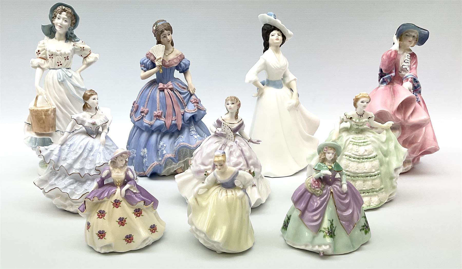 A group of figures, comprising four Royal Worcester examples, The Milkmaid, Lady Emma, Lady Cicely, Lady Hannah, three Royal Doulton examples, Top o' the Hill HN1849, Margaret HN2397, Fair Lady HN3216, two Coalport examples Fairest Flowers Heather, and Pansy, and a Wedgwood figure commissioned by Spink, The Imperial Banquet. 