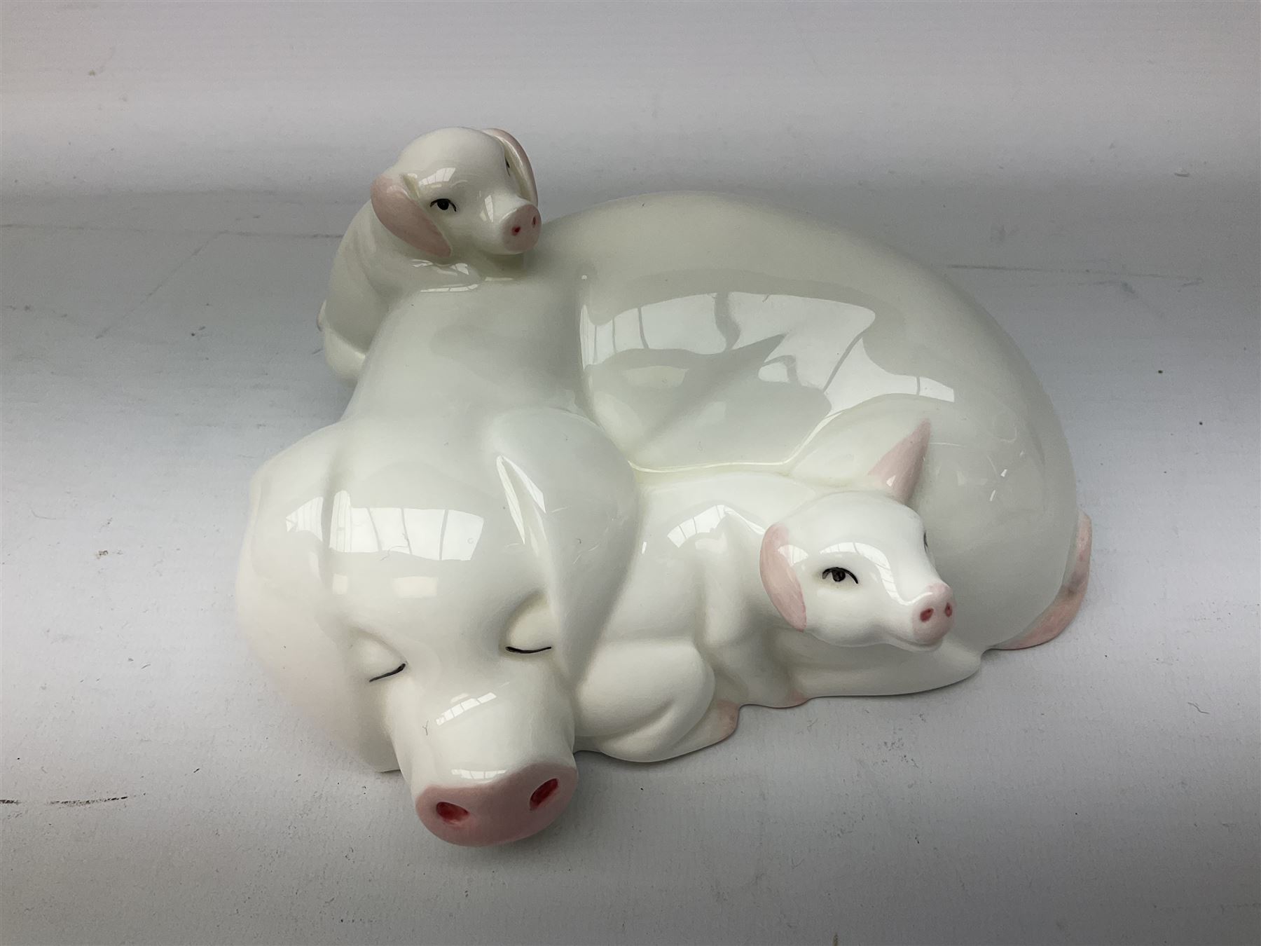 Collection of Beswick pig figures, to include John Beswick Little Likeables ‘Hide and Sleep’, white boar pig and John Beswick trio of pigs, all marked beneath (5)