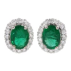Pair of 18ct white gold oval emerald and round brilliant cut diamond cluster stud earrings, stamped 18K, total emerald weight approx 2.50 carat, total diamond weight approx 0.75 carat