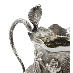 Middle Eastern silver cream jug and sugar bowl, embossed farming decoration, the jug with a cobra handle and two similar silver salts, approx 7oz (4)