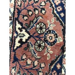Persian Herati design indigo and red ground carpet, decorated with floral motifs, arched border
