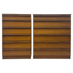 Avalon - two mid-20th century teak chests, with rectangular top above six graduated drawers, each fitted with recessed sculted pulls, raised on a flush plinth base.

(W 82cm D 55cm H 97cm)
(W 82cm D 55cm H 97cm)
