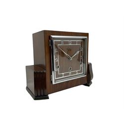  A  1930s “Bentima” Westminster chiming English art deco mantle clock in a stylised mahogany case with a square dial, chrome Arabic numerals and corresponding pierced hands within a chrome bezel, three train Perivale movement chiming the quarters on 4 gong rods, strike/silent facility. With pendulum and key. H24 



