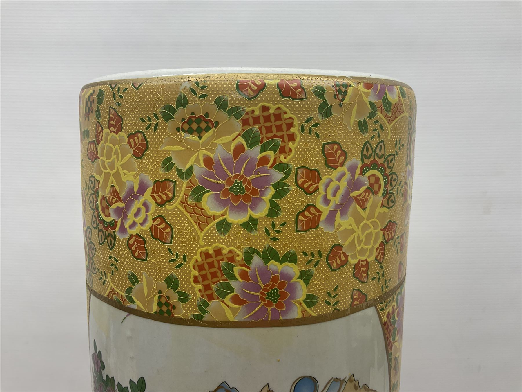 Modern Japanese ceramic umbrella stand, decorated with a figural panel on a yellow floral ground, H60cm