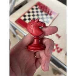 19th century walnut and brass bound games compendium box, painted to enhance the grain, of rectangular form, the hinged opening cover with rounded sides, central brass cartouche with engraved lion crest, and brass riveted straps, opening to reveal a red leather and blue silk lined compartmented interior, with fold-down games board, and lift-out tray containing playing cards, ebony turned dice towers, white and red stained bone draughts, and chess pieces, ivory dice, and ivory and ebony whist markers, and brass bezique board, cribbage board and markers, H15cm W32cm D24cm
This lot has been registered for sale under Section 10 of the APHA Ivory Act