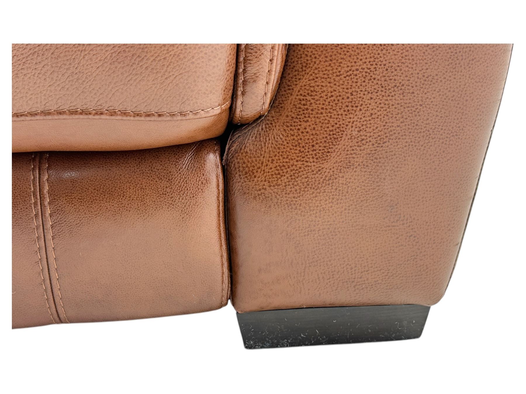 DFS - 'Liaison' reclining armchair upholstered in brown leather, upholstered in tan leather with stitched panel backrest and generously cushioned seat and arms, operated by wired remote, raised on block feet