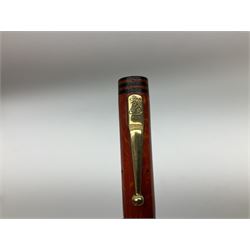 Vintage Swan Mabie Todd lever fill fountain pen in coral red, the nib a/f marked 14K, together with two further vintage Swan Mabie Todd fountain pens, the first example with lever fill, the other leverless, each with black body, one with nib marked 14ct, (3) 