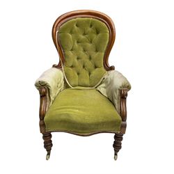 Victorian mahogany spoon back armchair, upholstered in buttoned green fabric, on turned supports
