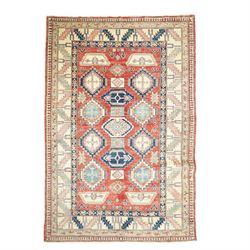 Caucasian Kazak hand-knotted rug, madder red field with bold geometric medallions and angu...