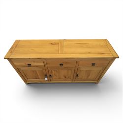 Contemporary oak sideboard, with rectangular top above three drawers and three cupboard doors, blackened metal handles, raised on stile supports