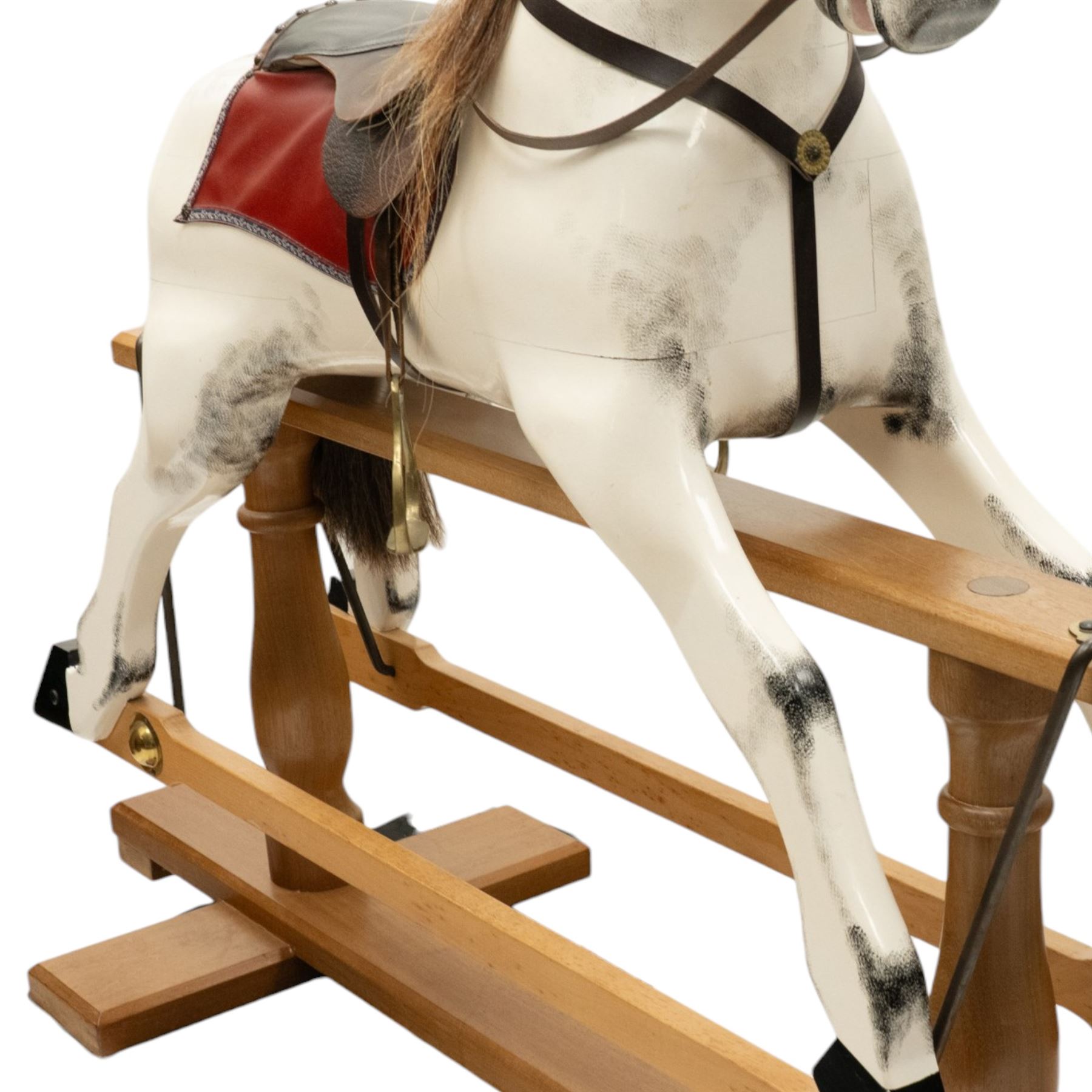 Late 20th century polychrome painted rocking horse, modelled in dapple grey finish with real hair mane and tail, leather tack and saddle, stirrups, raised on a natural wood safety trestle base
