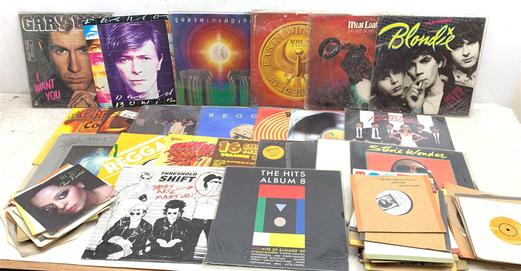 A collection of Vinyl records and singles, to include Stevie Wonder Hotter than July, Blondie Parallel Lines, Blondie Eat to the Beat, Meat Loaf Bat Out of Hell, Diana Ross Live, Bob Marley & The Wailers Coult You be Loved, David Bowie Fashion, Reggae Disco 45, Reggae Party Time Vol 2 Blooblo, etc. 