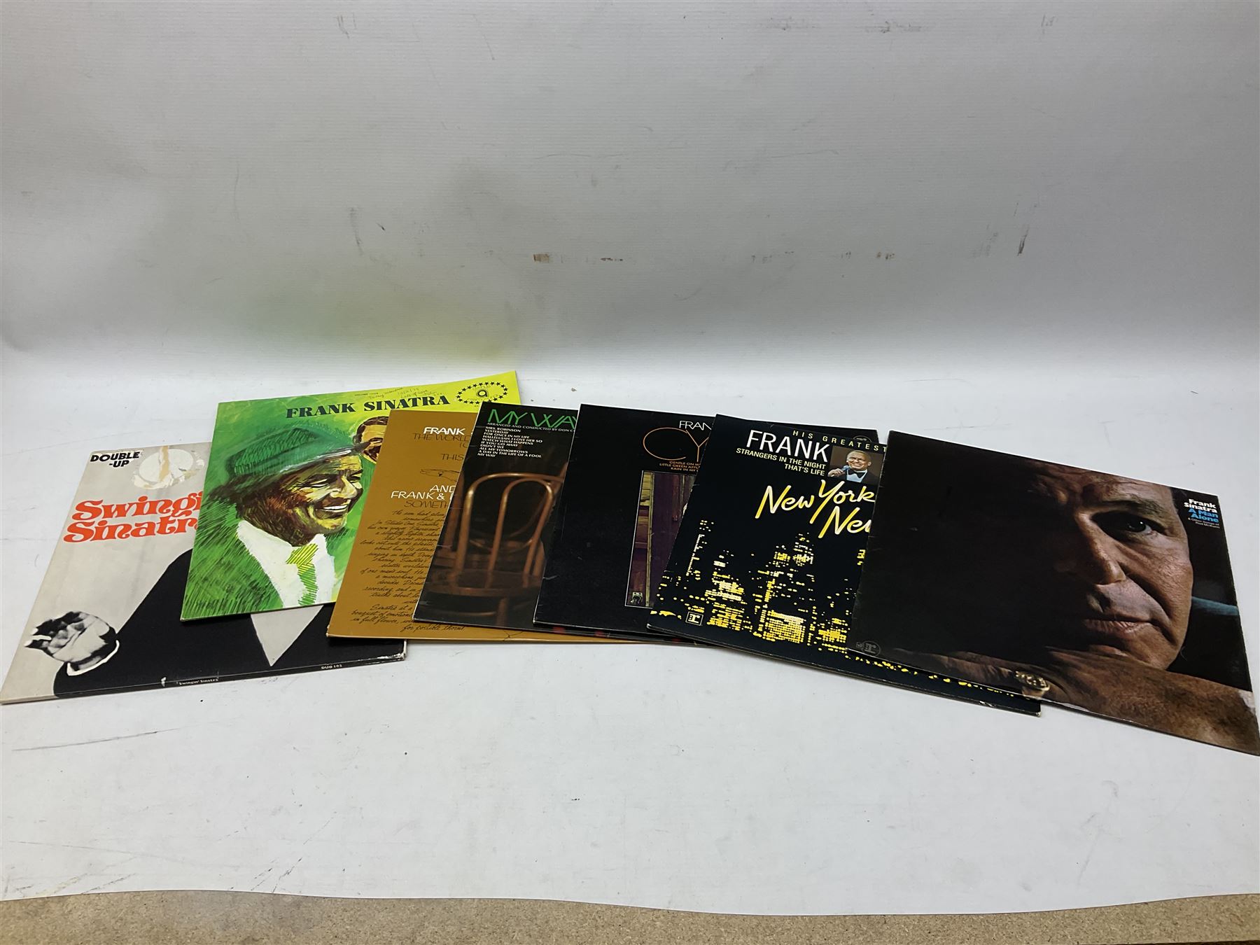 Collection of Frank Sinatra LP vinyl records, to include Sinatra Trilogy Past Present Future, Ol' blue eyes is back, My Way, etc., together with two books, The Sinatra Treasures by Charles Pignone, and Frank Sinatra by Jessica Hodge, plus a Beatles LP vinyl record, Love Songs, in one box