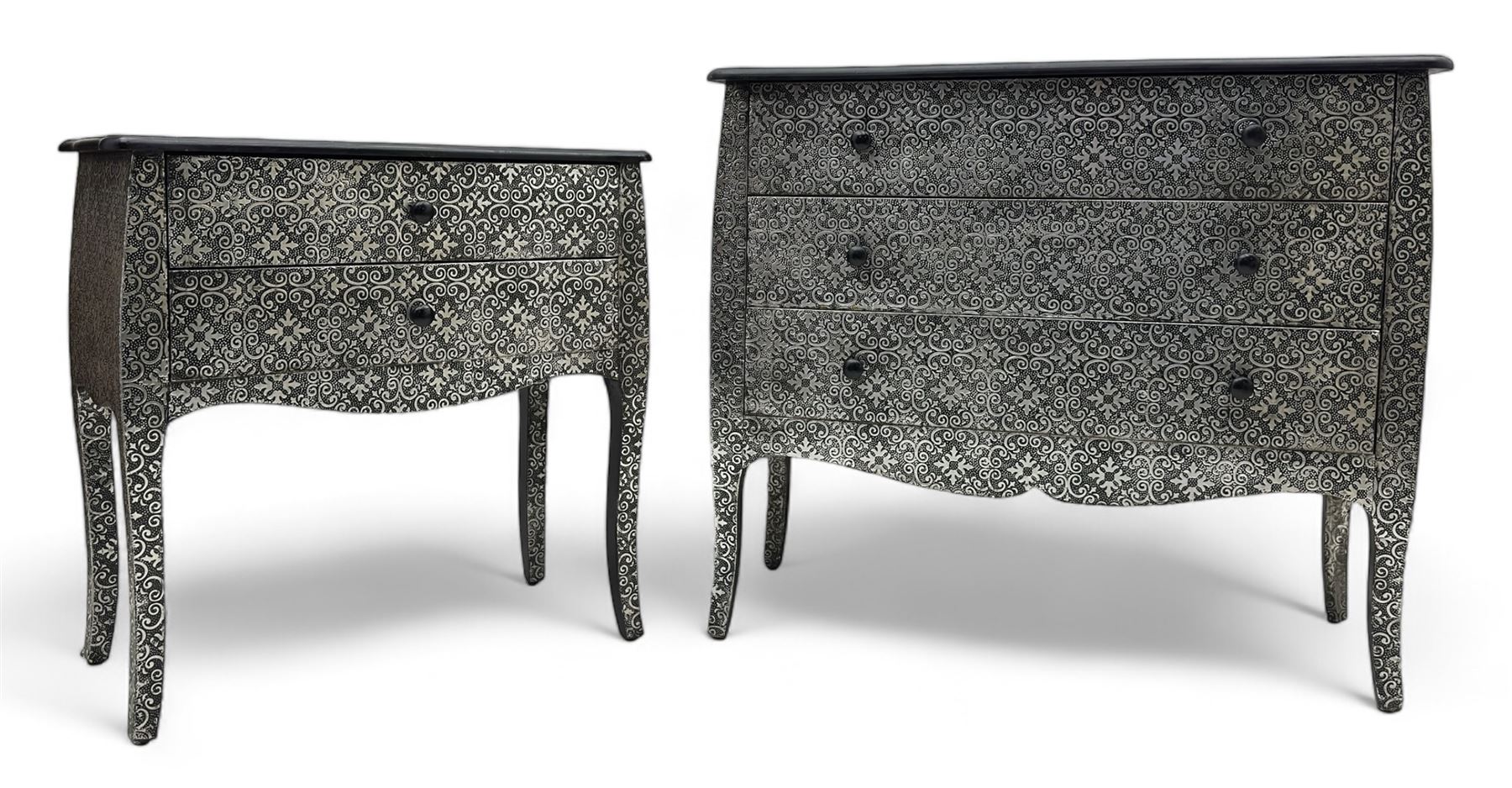 Contemporary black lacquered metal-clad chest, embossed with silver floral scrollwork, shaped rectangular top over three drawers, on cabriole supports (W89cm, D40cm, H79cm); matching two drawer chest (W68cm, D35cm, H67cm)