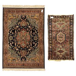 Belgian Sultan woollen ground rug, central navy field densely decorated with floral sprays and geometric patterns (192cm x 135cm); handwoven tribal terracotta ground rug (121cm x 71cm); Persian crimson ground runner, all over stylised floral and foliate motifs (266cm x 94cm)