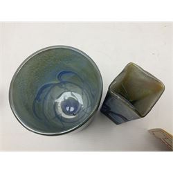 Two Isle of White glass vases, by Alum Bay Glass, both with blue swirl design upon an iridescent mottled blue/green ground, together with a Gozo Glass vase of pebble form, with similar design, H12cm