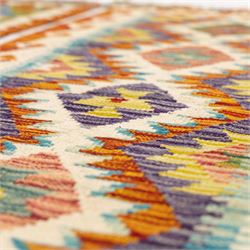 Two Chobi flatweave kilim runners with a repeating stepped diamond medallion design in live green, rust, teal, purple, and ivory, framed by chevron and geometric borders, (2)