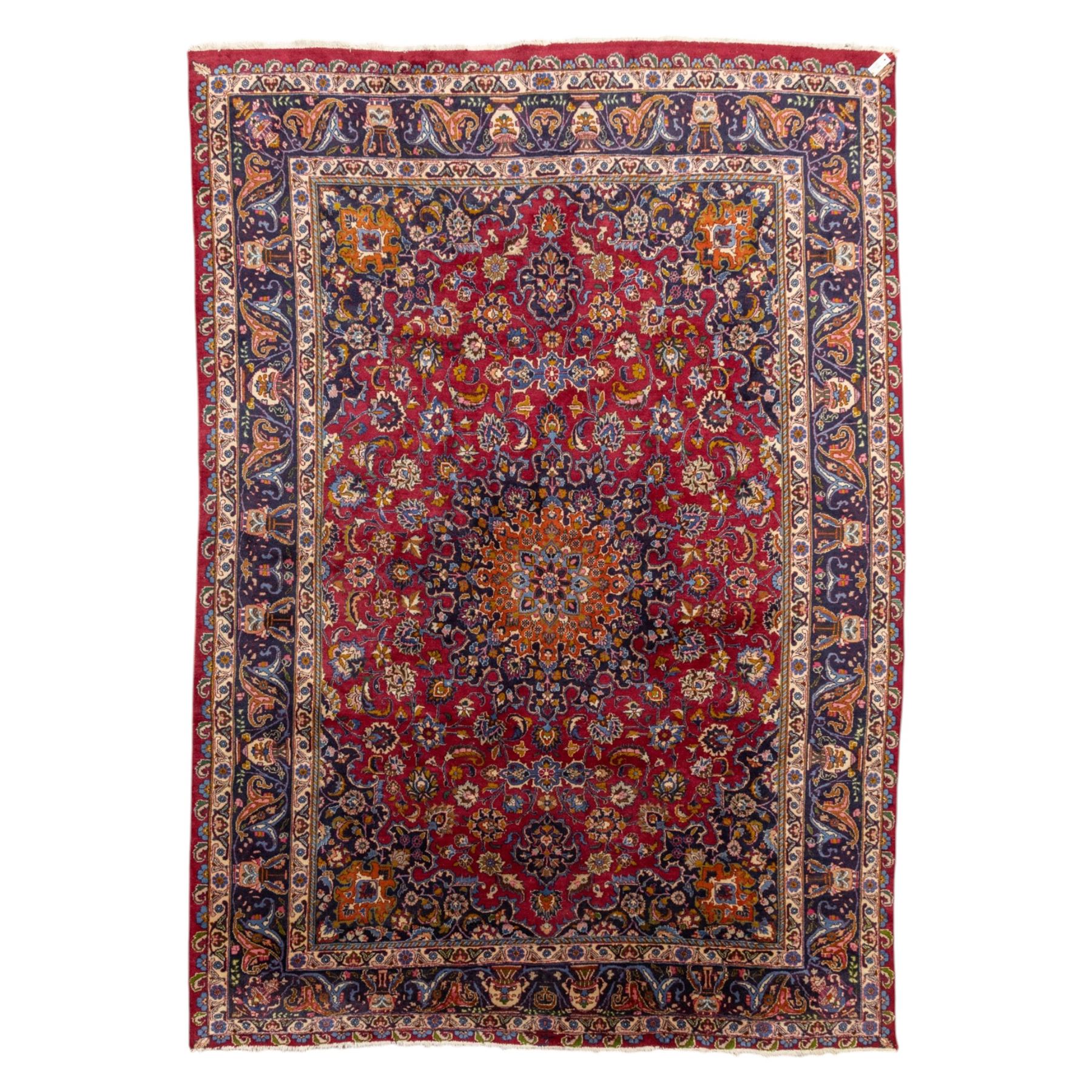 Persian Kashan wool carpet, red field centred with large floral medallion and conforming pendants, decorated with scrolling foliage and flowerheads, indigo spandrels and borders, from the region of Kashan