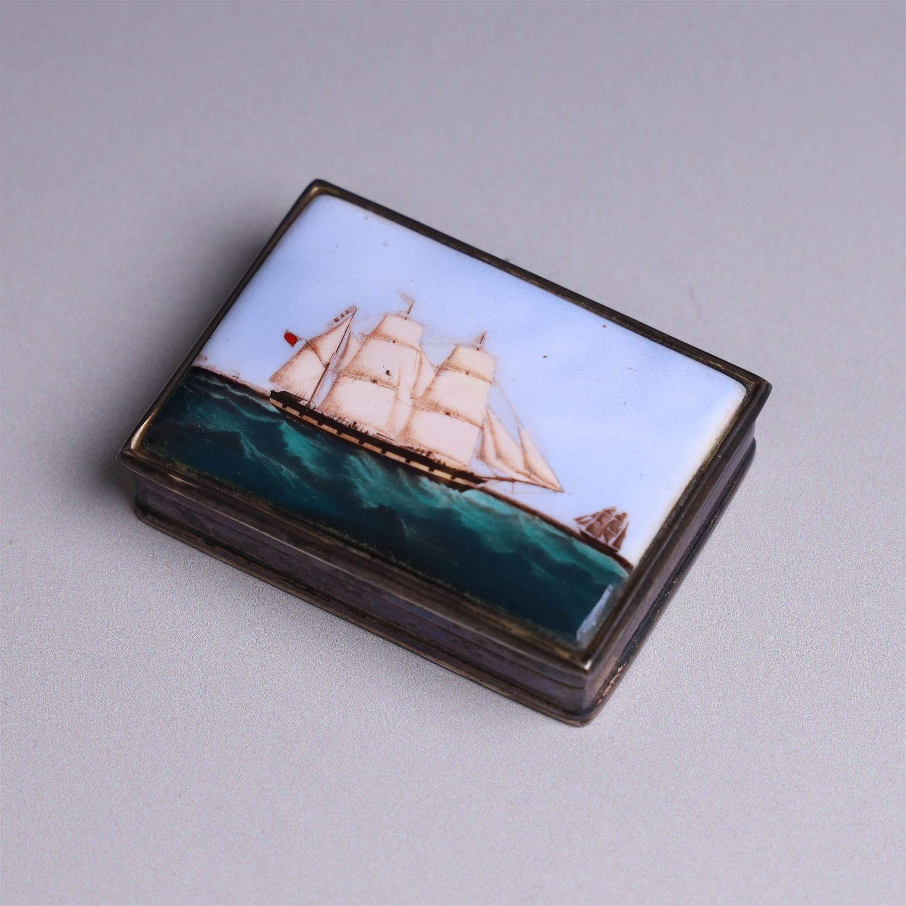 Modern silver box, with enamel plaque to hinged lid depicting a ship at full sail, stamped 925