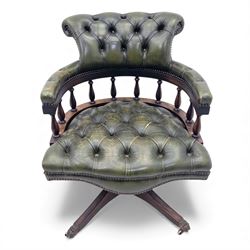 Mid 20th century buttoned green leather office chair, the curved back and arms over a circular frame with turned spindle supports, on a revolving base with four splayed legs and brass castors