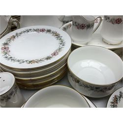 Royal Albert Paragon tea and dinner service for twelve decorated in the Belinda pattern, comprising fourteen saucers, twelve teacups, thirteen side plates, teapot, sauce boat and stand, salt and pepper shakers, two jugs, sucrier, twelve dinner plates, twelve smaller plates, two lidded tureens, twelve bowls, twelve smaller bowls, cake plate, oval plate and oval dish (100)