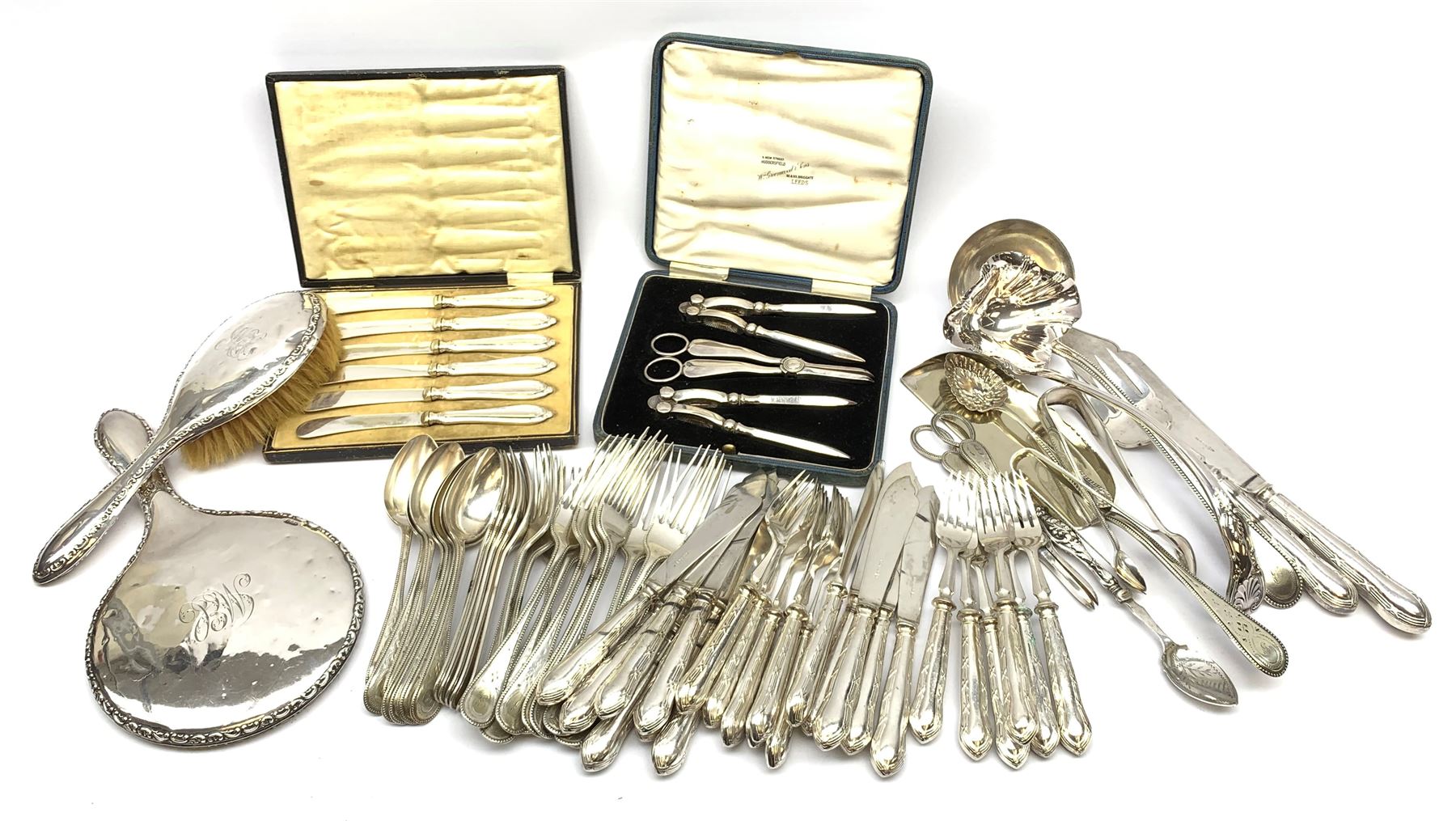 Two silver napkin rings by Collingwood & Sons Ltd, Birmingham 1928 and two other silver napkin rings hallmarked, approx 3.2oz, cased set of silver silver handled knives, hallmarked Sheffield 1915, together with a selection of silver plated flatware, to include Walker and Hall fish eaters set, cased nut cracker set with grape scissors, etc., plus a silver mounted hair brush and hand held mirror, hallmarked Chester 1919