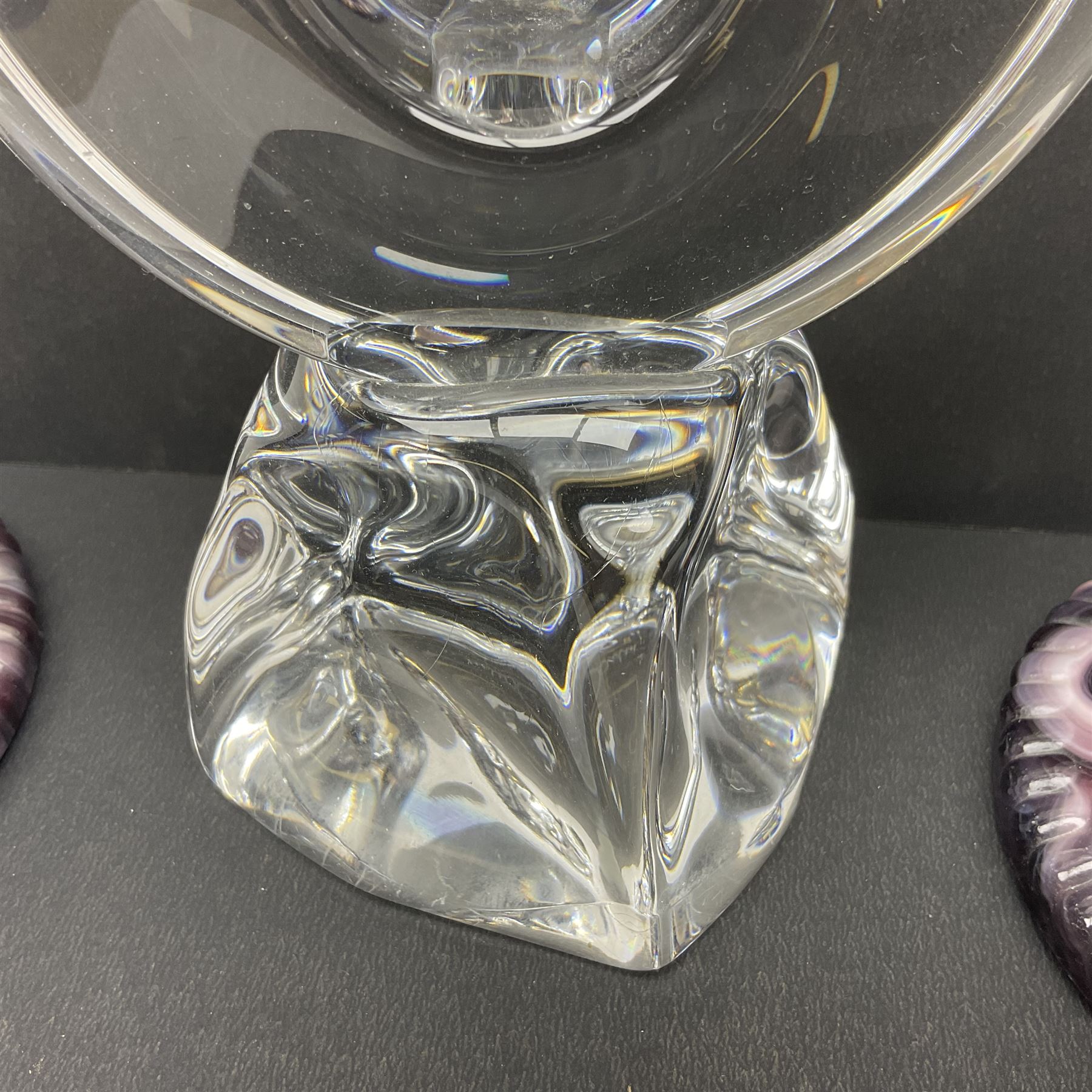 Daum glass two stemmed candle stick signed to verso, together with a pair of slag glass purple candle sticks, Daum H21cm