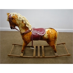  Late 20th century red and gold rocking horse, with bridle, saddle and stirrups, L145cm  