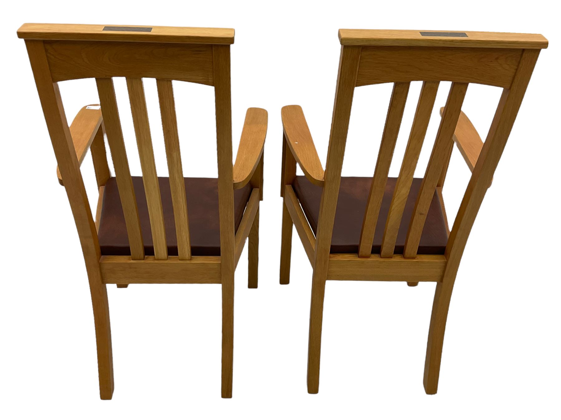 Pair of solid oak Arts and Crafts style carver chairs, inlay to top rail, drop in seat