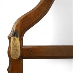 Early 20th-century taxidermy decorated wall-mounted gun rack, shaped oak frame fitted with used shotgun cases and mounted with hooves designed to hold shotguns horizontally, surmounted with a taxidermy deer head 