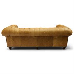 Distinctive Chesterfields - traditional shape four seater Chesterfield sofa, the rolled back and arms upholstered in deep-buttoned tan leather with matching loose seat cushions, raised on six turned supprorts