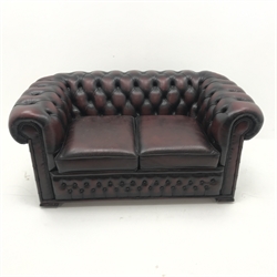 Two seat chesterfield sofa upholstered in deep buttoned ox blood leather, W155cm
