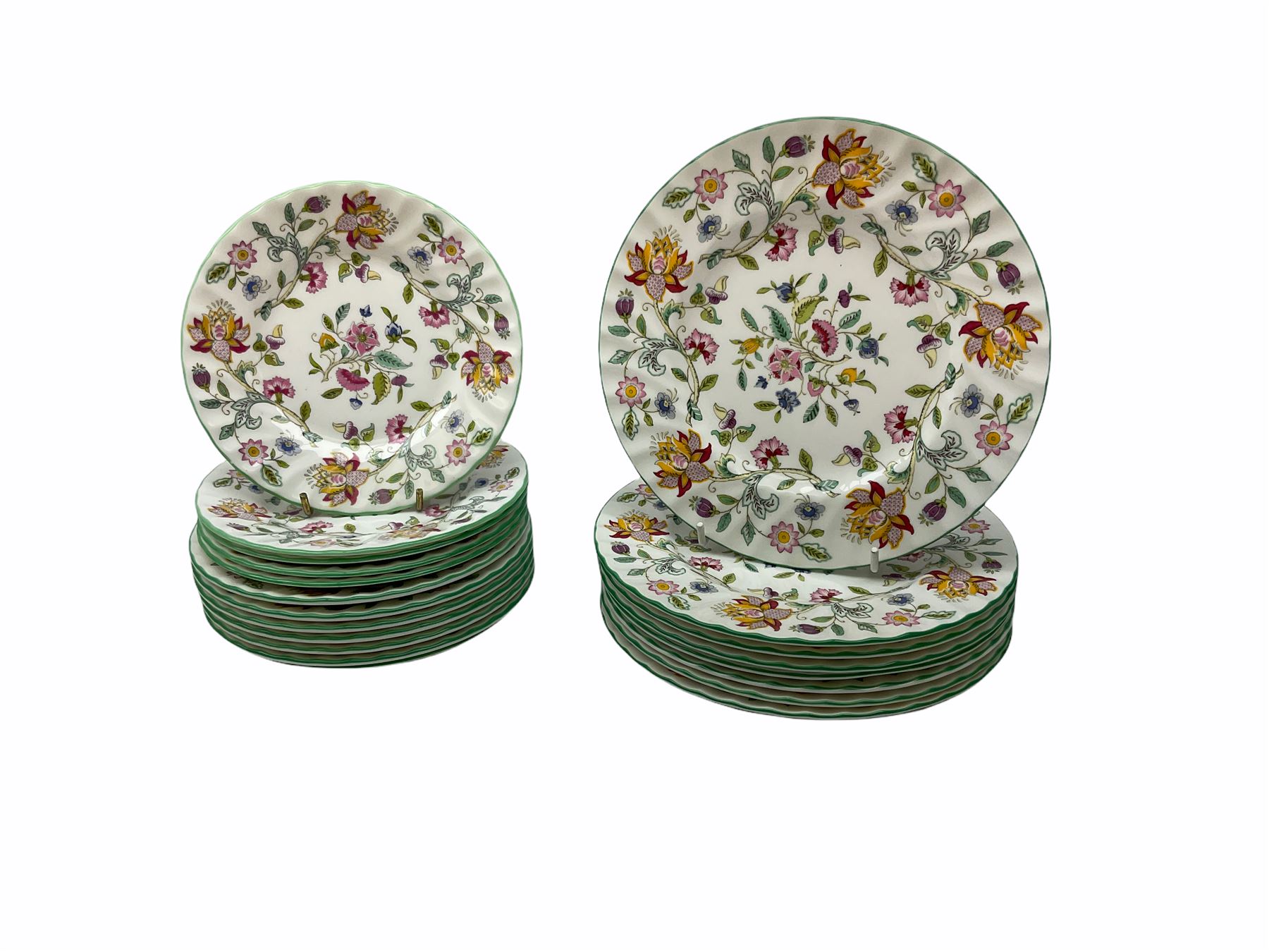 Minton Haddon Hall pattern tea and dinner wares, including basket dish, two covered tureens, six dinner plates, eight dessert plates, twelve tea plates, six soup bowls, six cereal bowls, teapot, coffee pot, milk jug, covered sucrier twelve tea cups and saucers, six mugs, footed bon bon dish, pair of candlestick holders, cake knife and slice etc (81)