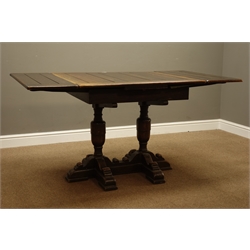  Early 20th century oak drawer leaf dining table, twin pillar base, H76cm, 84cm x 154cm (open)  