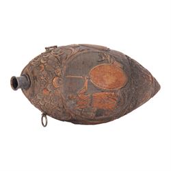Early 19th century carved coconut 'bugbear' flask, carved with circular panel of Justice stood by a vacant oval shield, holding scales and sword aloft, and stood upon a serpent, and a vignette carved with figures in merriment, drinking and playing music, with profusely carved foliate detail to the rest of the body, the top carved with typical grotesque face with inset glass eyes, and metal nozzle mouthpiece, including mouthpiece L17.5cm 


