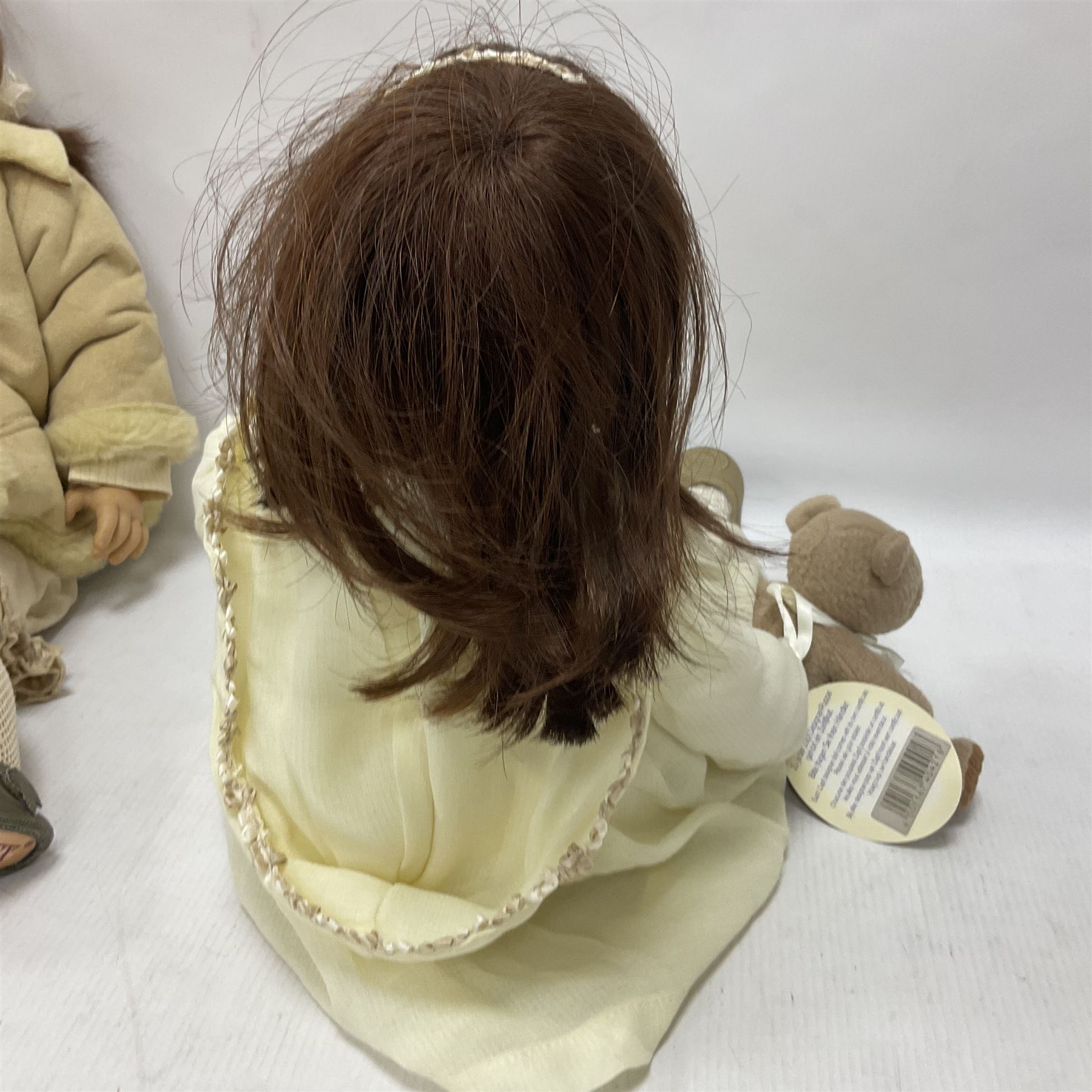 Two Zapf Creation limited edition designer collection dolls, by Brigette Paetsch, the first example with faux suede jacket, red jumper and denim skirt, no. 460, the second example 'Linda' in white dress with teddy bear accessory, no. 785, each signed B Paetsch, tallest L60cm