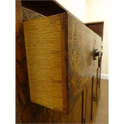  Arts & Crafts oak sideboard, raised arched back with single shelf, above two drawers, four cupboards and a recess, with brass ring handles, on shaped bracket feet, W155cm, H127cm, D42cm  