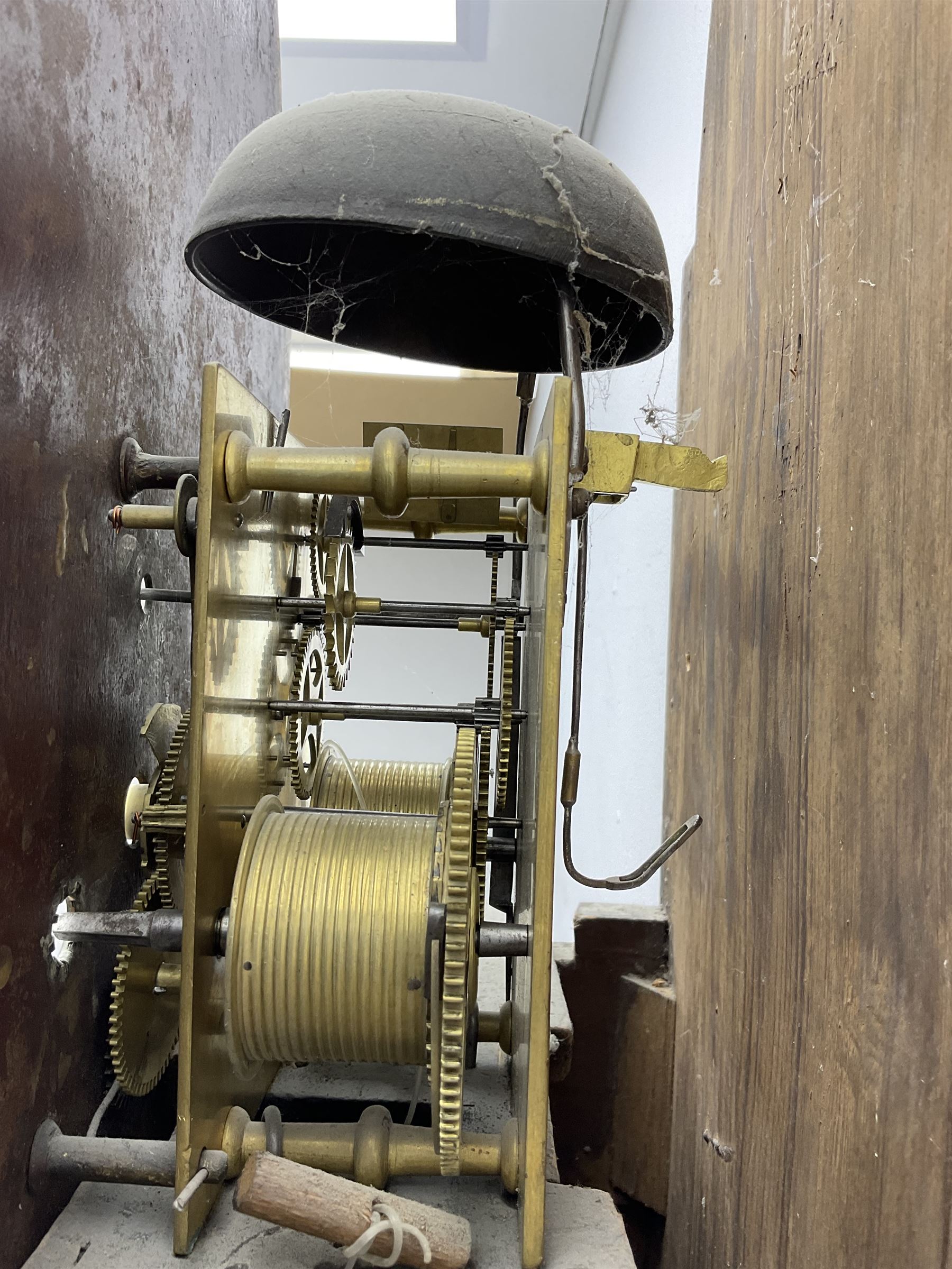 Ayers of Newcastle - 19th century oak cased 8 day longcase clock c1850, with a break-arch top and turned wooden finials, conforming hood door flanked by waisted pilasters and brass capitals, trunk door with an arched top, rectangular plinth with decorative base, painted dial with floral spandrels and a rural depiction to the arch, Roman numerals and minute track, with matching brass hands and subsidiary seconds and date dials, dial pinned directly to a rack striking movement, sounding the hours on a bell. With pendulum and weights.