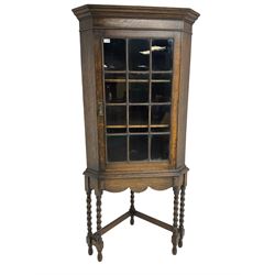 Early to mid-20th century oak corner display cabinet, projecting cornice over astragal gla...